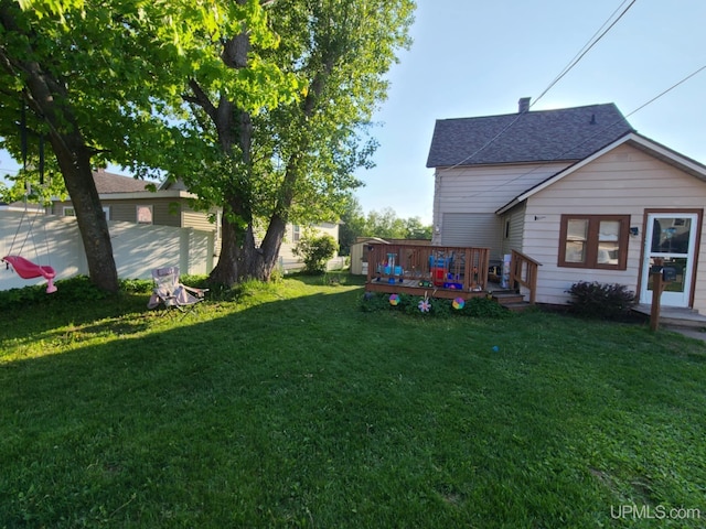 1110 N 2nd St, Ishpeming, MI 49849 - view of green lawn with a deck and a storage unit
