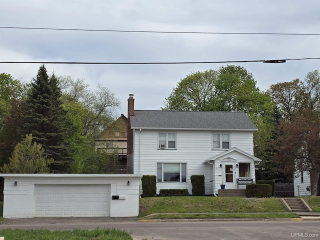 817 W Water St, Hancock, MI 49930 - view of front of home featuring a chimney, a garage, and a front lawn