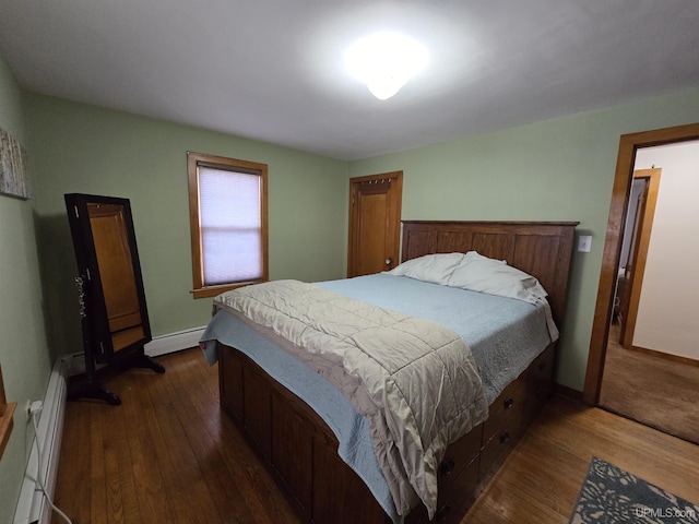 817 W Water St, Hancock, MI 49930 - bedroom featuring baseboard heating, dark wood-style flooring, and baseboards