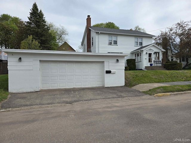 817 W Water St, Hancock, MI 49930 - view of front facade with a chimney and a garage