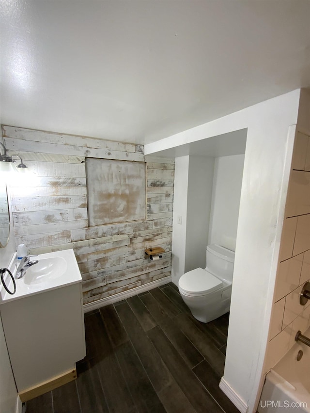 331 W Bluff St, Marquette, MI 49855 - full bath featuring vanity, wood finished floors, toilet, wood walls, and shower / bathtub combination