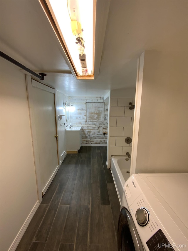 331 W Bluff St, Marquette, MI 49855 - full bathroom featuring washer / dryer, a tub to relax in, wood finished floors, a shower, and baseboards