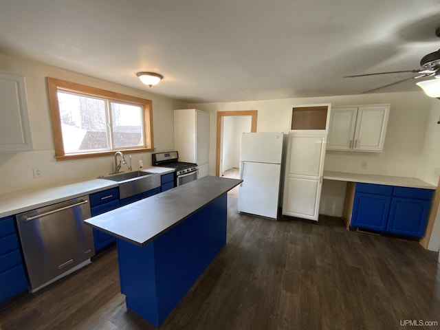 331 W Bluff St, Marquette, MI 49855 - kitchen featuring stainless steel appliances, blue cabinets, a sink, and white cabinets