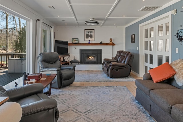 5001 Ruby Dr, Gladwin, MI 48624 - living room featuring hardwood / wood-style flooring and a warm lit fireplace