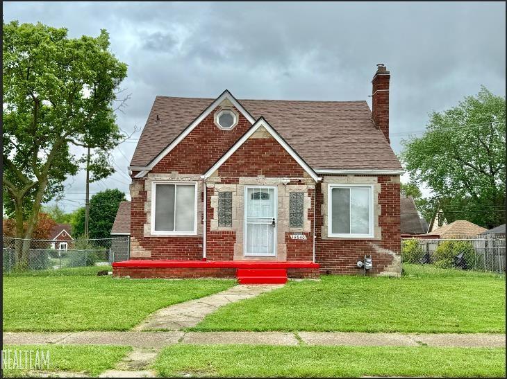 14840 Eastburn St, Detroit, MI 48205 - view of front of property featuring a shingled roof, brick siding, and a chimney
