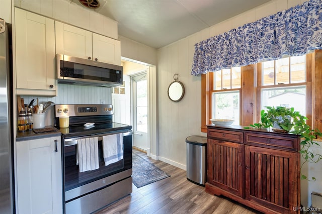 546N W Gulliver Lake Rd, Gulliver, MI 49840 - kitchen with appliances with stainless steel finishes, wood finished floors, dark countertops, baseboards, and white cabinetry
