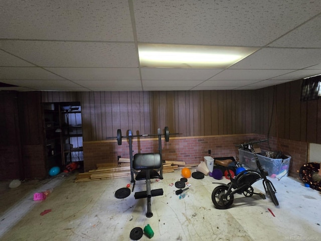 711 Moore St, Owosso, MI 48867 - exercise area featuring a paneled ceiling and wood walls