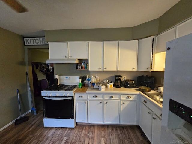 711 Moore St, Owosso, MI 48867 - kitchen featuring white appliances, dark wood-type flooring, white cabinetry, and under cabinet range hood