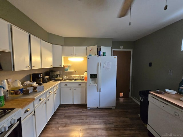 711 Moore St, Owosso, MI 48867 - kitchen with white appliances, a sink, dark wood-style flooring, white cabinetry, and light countertops