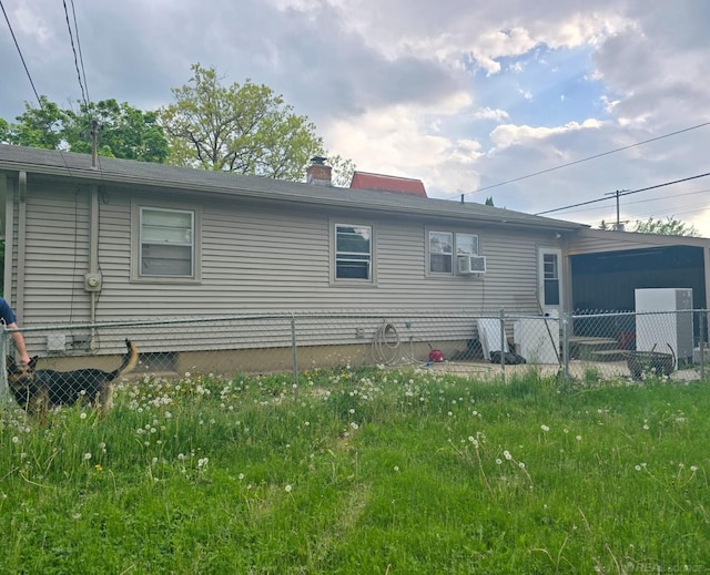 711 Moore St, Owosso, MI 48867 - rear view of property featuring a chimney and cooling unit