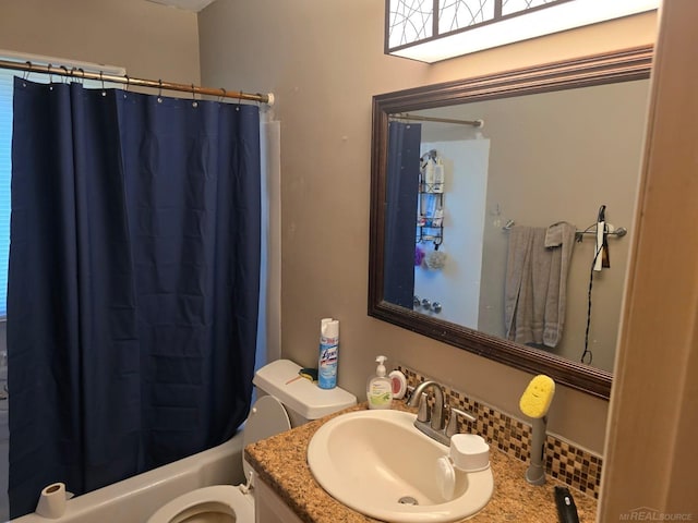 711 Moore St, Owosso, MI 48867 - full bath featuring vanity, toilet, and shower / tub combo