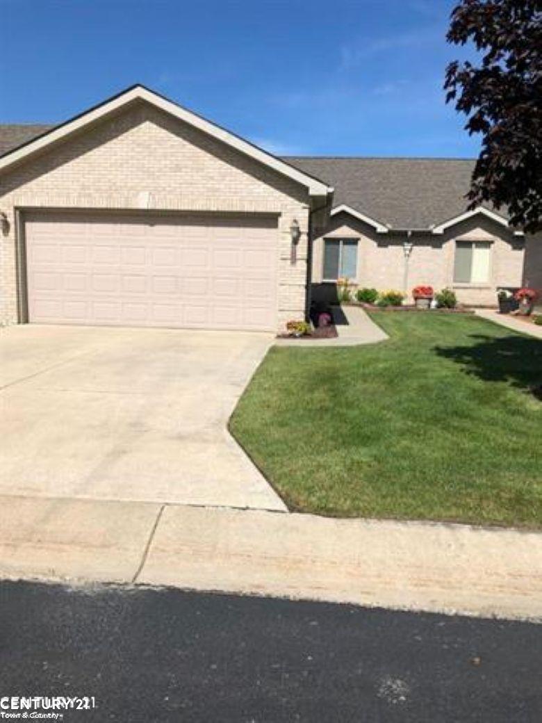 35283 Silver Maple Dr Unit 38, Clinton Township, MI 48035 - single story home with an attached garage, concrete driveway, a front yard, and brick siding