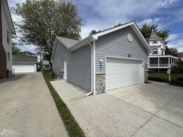 1741 Saint Clair River Dr, Algonac, MI 48001 - view of side of home with stone siding, cooling unit, and an outdoor structure