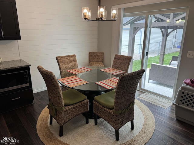 1741 Saint Clair River Dr, Algonac, MI 48001 - dining room with dark wood finished floors, a chandelier, and wooden walls