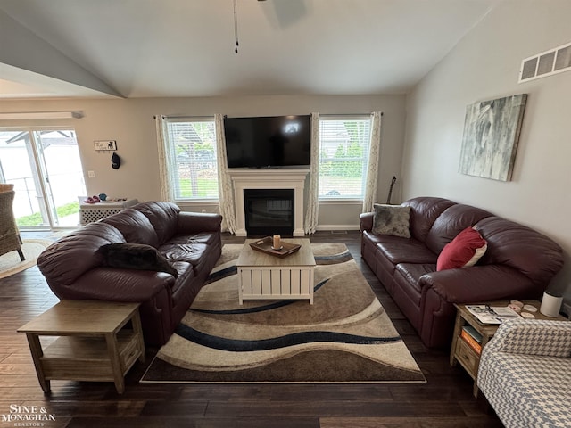 1741 Saint Clair River Dr, Algonac, MI 48001 - living room featuring lofted ceiling, healthy amount of natural light, dark wood-type flooring, and a glass covered fireplace