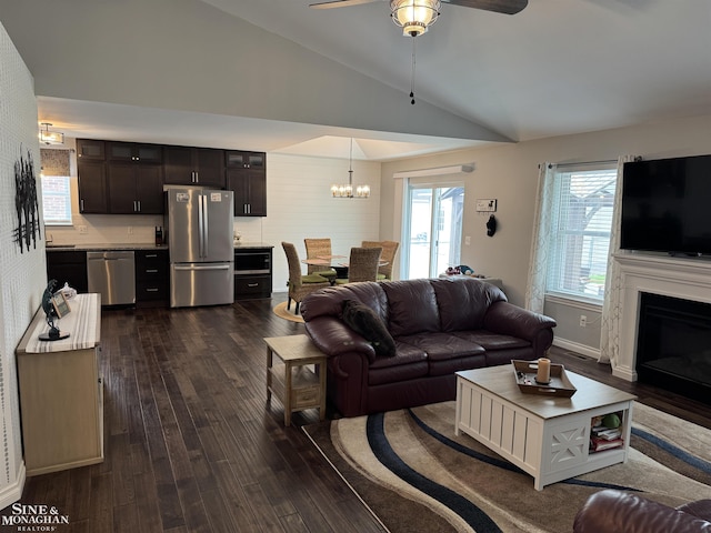 1741 Saint Clair River Dr, Algonac, MI 48001 - living area with ceiling fan, a chandelier, dark wood-style floors, a glass covered fireplace, and high vaulted ceiling