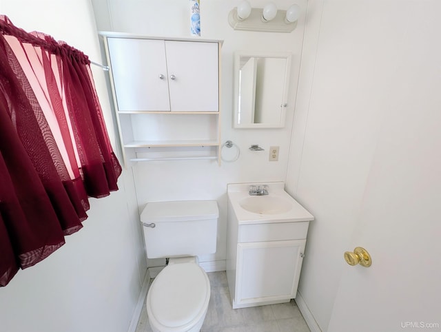 116 Caribou St, Gwinn, MI 49841 - half bathroom with vanity, toilet, baseboards, and tile patterned floors