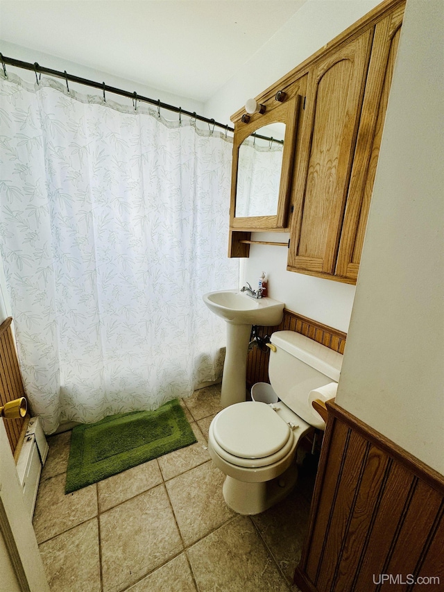 584 Elliott Ave, Ishpeming, MI 49849 - bathroom featuring toilet, tile patterned floors, and curtained shower