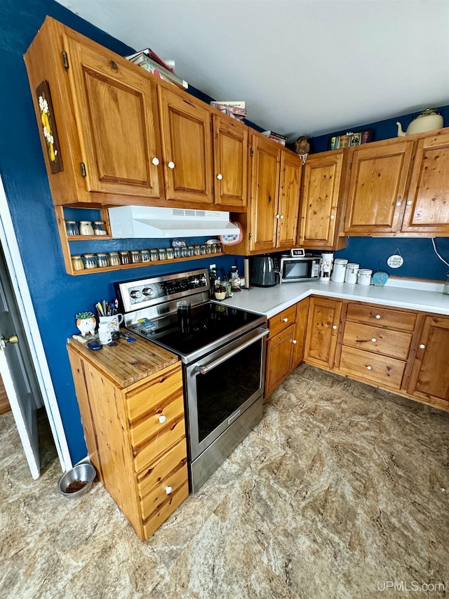 584 Elliott Ave, Ishpeming, MI 49849 - kitchen featuring stainless steel appliances, under cabinet range hood, brown cabinetry, and light countertops