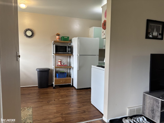 8401 18 Mile Rd Unit 154, Sterling Heights, MI 48313 - kitchen featuring freestanding refrigerator, stainless steel microwave, dark wood-style flooring, and white cabinets