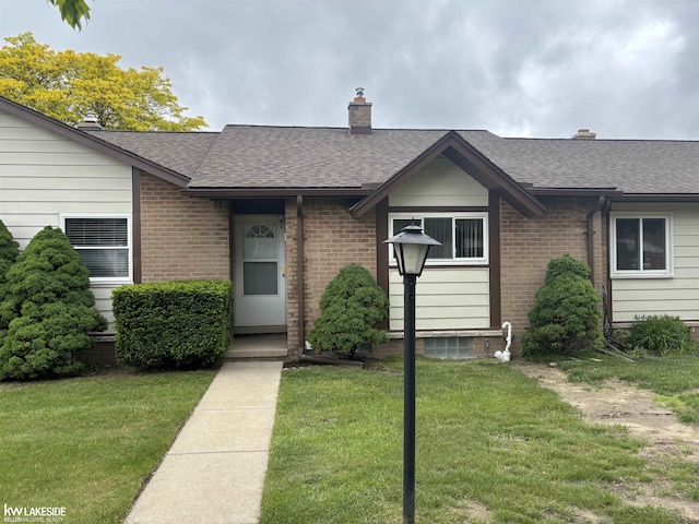 8401 18 Mile Rd Unit 154, Sterling Heights, MI 48313 - ranch-style house with a shingled roof, a front yard, and brick siding