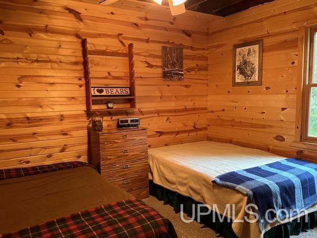 325 Mastodon Rd, Crystal Falls, MI 49920 - bedroom featuring wood walls