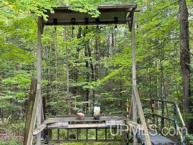 325 Mastodon Rd, Crystal Falls, MI 49920 - wooden deck with a wooded view