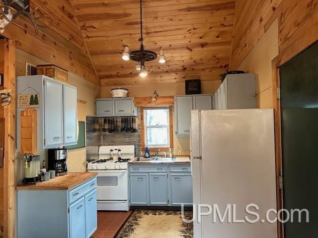 325 Mastodon Rd, Crystal Falls, MI 49920 - kitchen with white appliances, lofted ceiling, wooden ceiling, a sink, and dark tile patterned flooring
