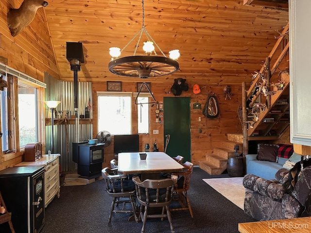 325 Mastodon Rd, Crystal Falls, MI 49920 - dining area featuring wood walls, healthy amount of natural light, and vaulted ceiling