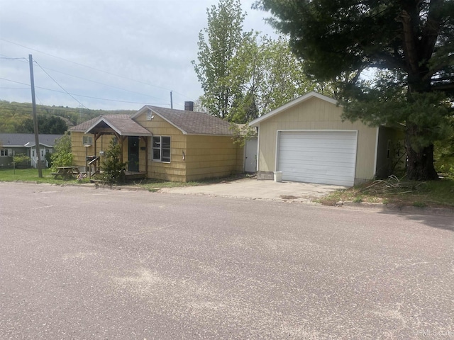 210 Birch St, Hancock, MI 49930 - ranch-style house featuring a detached garage and an outdoor structure
