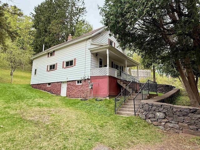 300 Jasper St, Ishpeming, MI 49849 - view of side of property with stairway and a yard