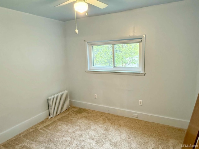 300 Jasper St, Ishpeming, MI 49849 - carpeted spare room featuring radiator, ceiling fan, and baseboards