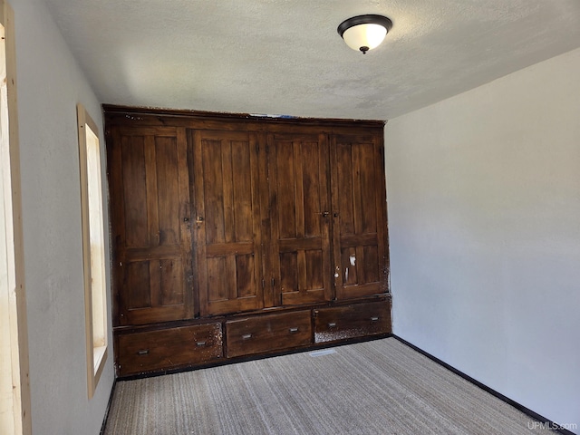 601 Range St, Manistique, MI 49854 - unfurnished bedroom with light carpet and baseboards
