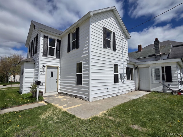 601 Range St, Manistique, MI 49854 - view of front of home with a front yard and a shingled roof
