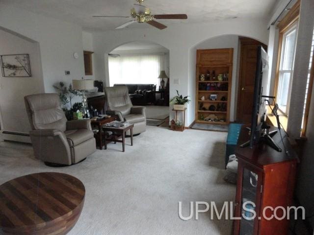 201 E Jewell St, Munising, MI 49862 - living area with arched walkways, a ceiling fan, carpet, and baseboard heating
