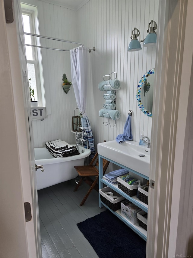 2450 N Lakeshore Rd, Carsonville, MI 48419 - bathroom featuring wood finished floors, healthy amount of natural light, and wooden walls