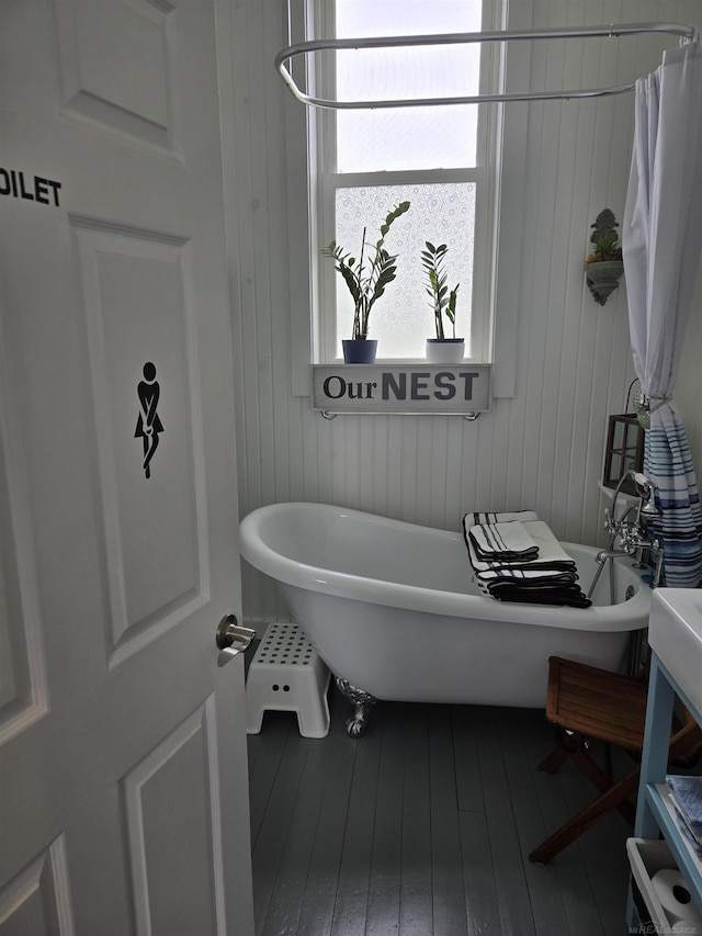 2450 N Lakeshore Rd, Carsonville, MI 48419 - bathroom featuring a soaking tub and hardwood / wood-style flooring