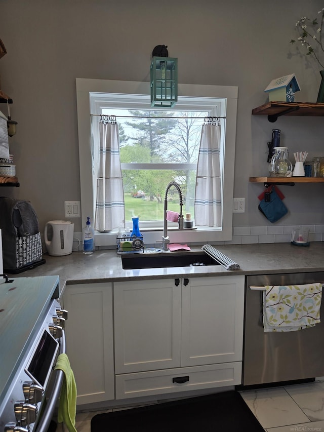 2450 N Lakeshore Rd, Carsonville, MI 48419 - kitchen featuring stainless steel dishwasher, a sink, white cabinetry, light countertops, and open shelves