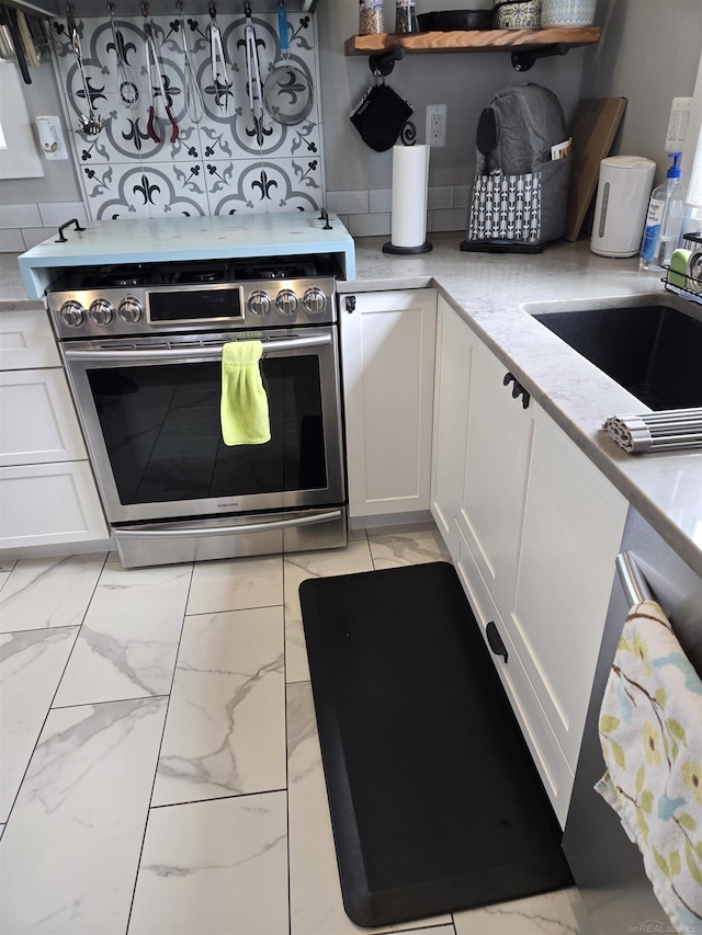 2450 N Lakeshore Rd, Carsonville, MI 48419 - kitchen featuring stainless steel range, light marble finish flooring, a sink, and white cabinetry