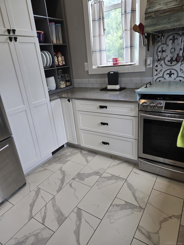 2450 N Lakeshore Rd, Carsonville, MI 48419 - kitchen featuring stainless steel range with electric cooktop, light marble finish flooring, white cabinets, and extractor fan