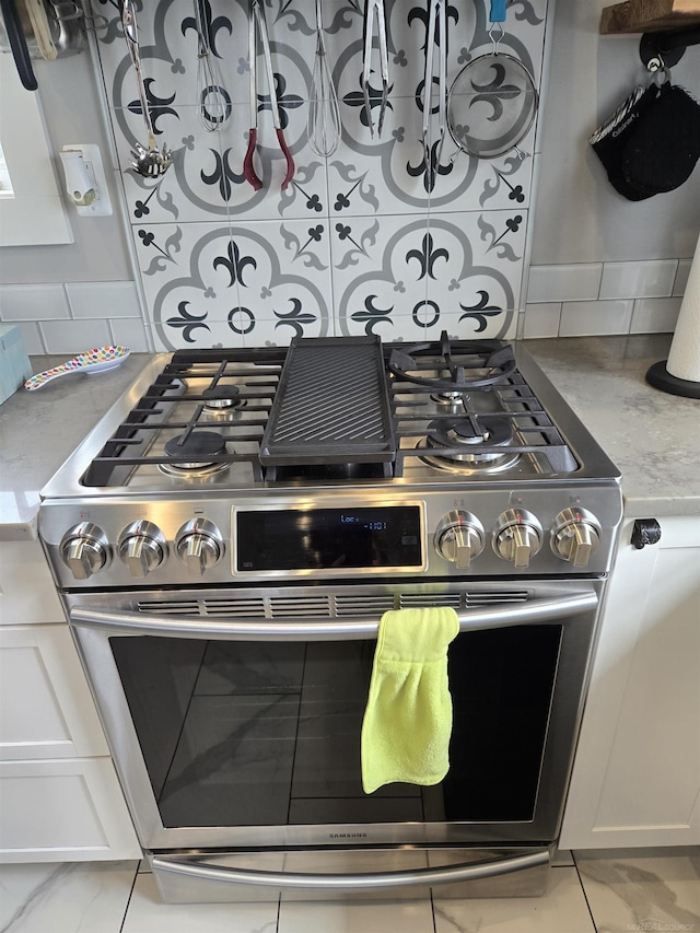 2450 N Lakeshore Rd, Carsonville, MI 48419 - detailed view of gas range, backsplash, and light countertops