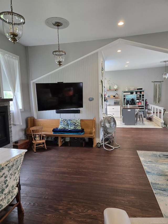 2450 N Lakeshore Rd, Carsonville, MI 48419 - living room featuring wood finished floors, vaulted ceiling, a fireplace, a chandelier, and recessed lighting