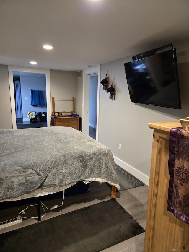 2450 N Lakeshore Rd, Carsonville, MI 48419 - bedroom with wood finished floors, recessed lighting, and baseboards