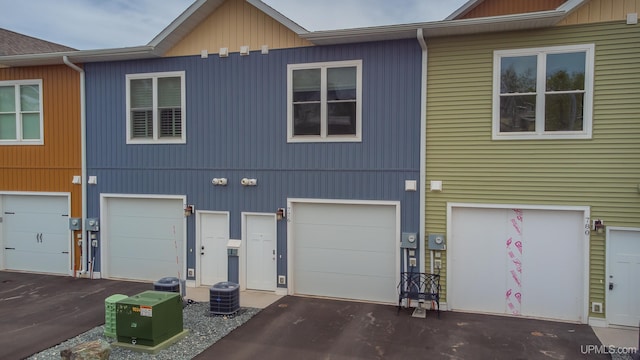 776 S Lakeshore Blvd, Marquette, MI 49855 - view of front of house with driveway, an attached garage, and central AC