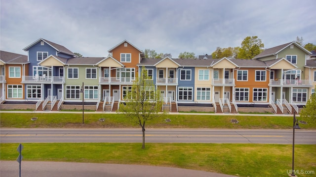776 S Lakeshore Blvd, Marquette, MI 49855 - view of front of home featuring a balcony, a residential view, and a front lawn