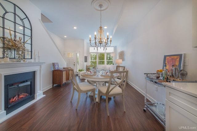 776 S Lakeshore Blvd, Marquette, MI 49855 - dining area with dark wood-type flooring, a chandelier, baseboards, a glass covered fireplace, and recessed lighting