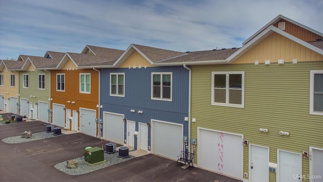 776 S Lakeshore Blvd, Marquette, MI 49855 - view of side of home with driveway, a shingled roof, and an attached garage