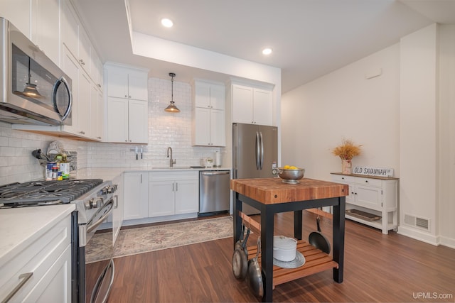 776 S Lakeshore Blvd, Marquette, MI 49855 - kitchen featuring stainless steel appliances, a sink, dark wood finished floors, decorative backsplash, and white cabinets