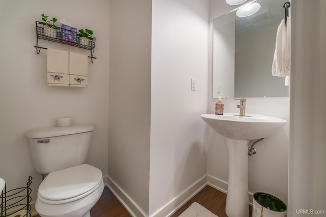 776 S Lakeshore Blvd, Marquette, MI 49855 - bathroom featuring toilet, wood finished floors, and baseboards
