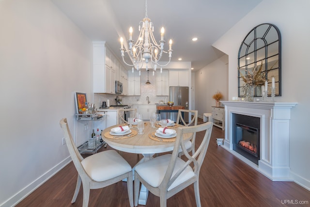 776 S Lakeshore Blvd, Marquette, MI 49855 - dining space featuring a chandelier, baseboards, dark wood finished floors, a glass covered fireplace, and recessed lighting